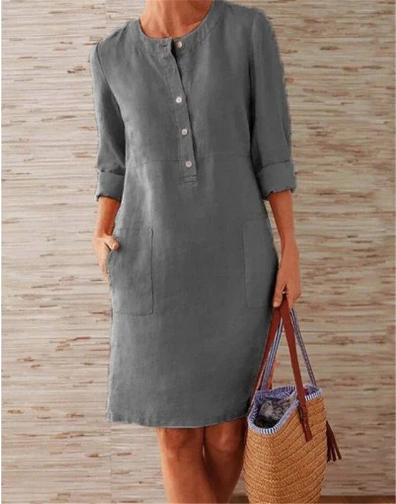 Flowy cotton and linen dress with vintage-inspired silhouette and button detailing, perfect for comfortable summer wear in the United Kingdom