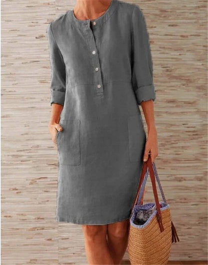 Flowy cotton and linen dress with vintage-inspired silhouette and button detailing, perfect for comfortable summer wear in the United Kingdom