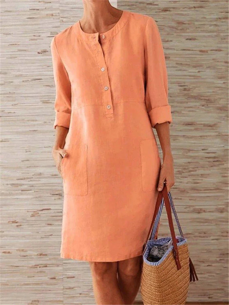Flowy cotton and linen dress with vintage-inspired silhouette and button detailing, perfect for comfortable summer wear in the United Kingdom
