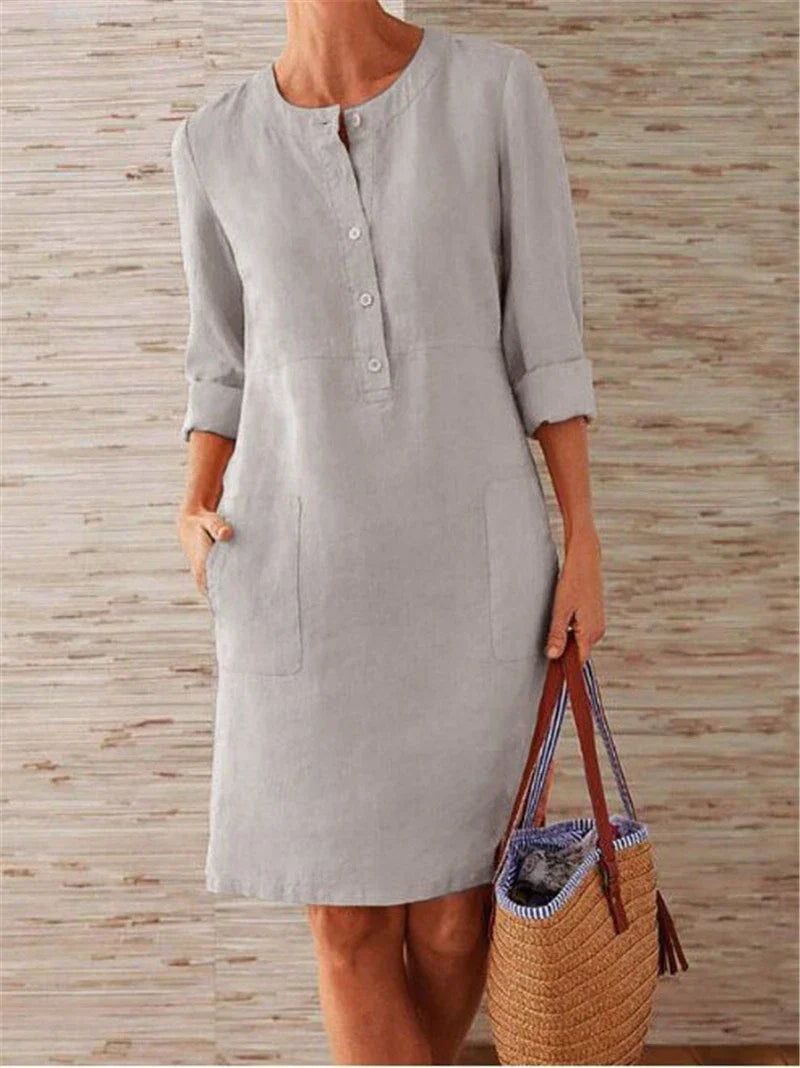 Flowy cotton and linen dress with vintage-inspired silhouette and button detailing, perfect for comfortable summer wear in the United Kingdom