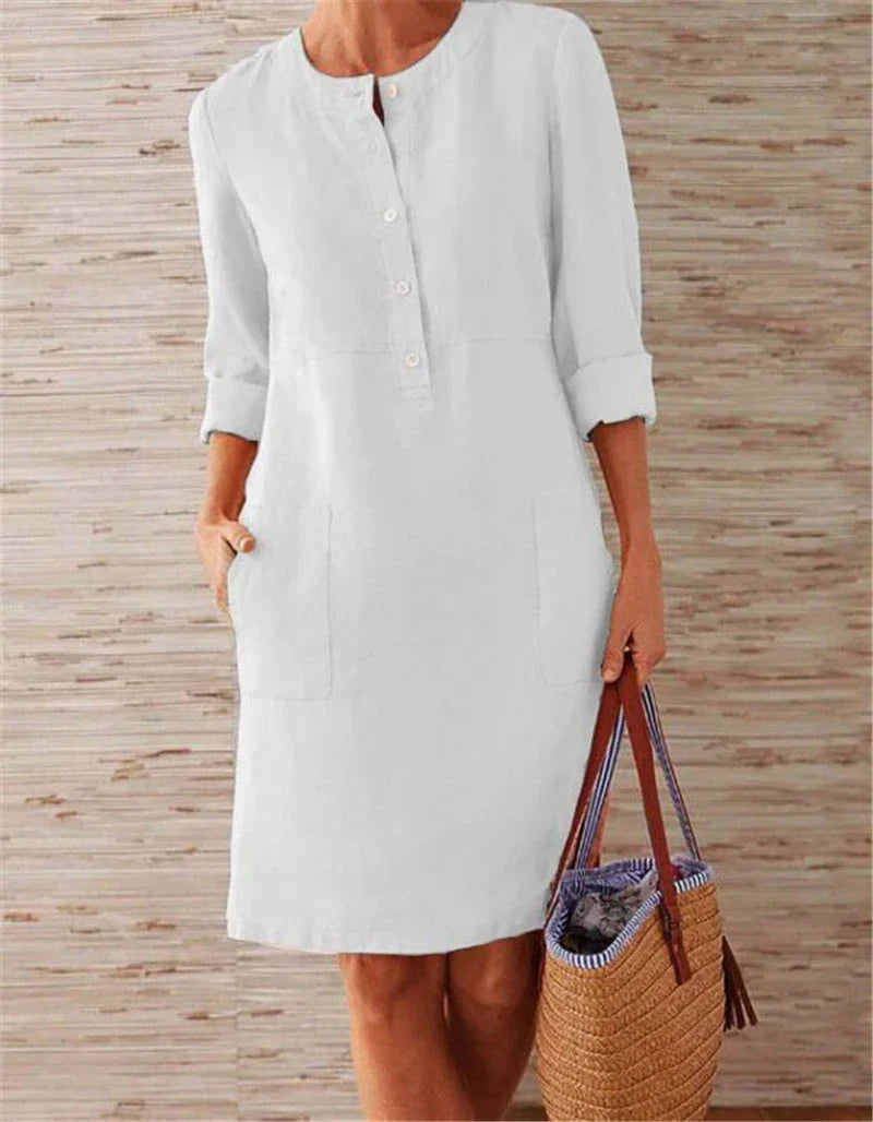 Flowy cotton and linen dress with vintage-inspired silhouette and button detailing, perfect for comfortable summer wear in the United Kingdom
