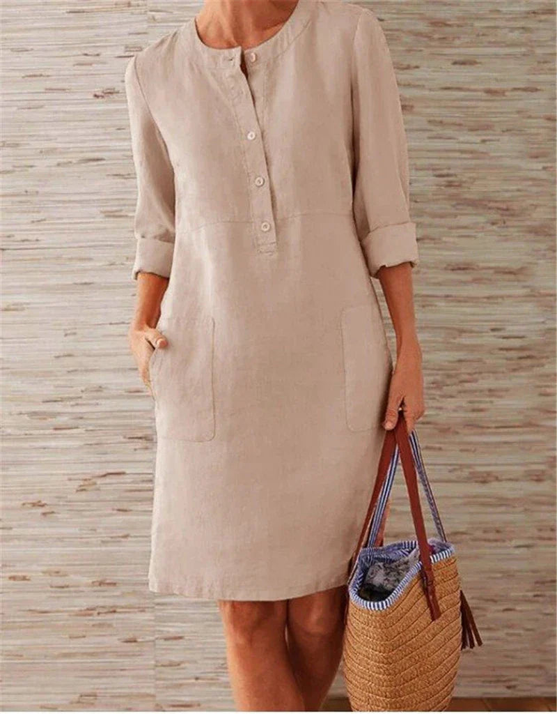 Flowy cotton and linen dress with vintage-inspired silhouette and button detailing, perfect for comfortable summer wear in the United Kingdom