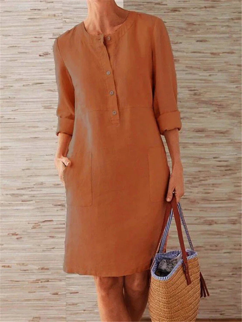 Flowy cotton and linen dress with vintage-inspired silhouette and button detailing, perfect for comfortable summer wear in the United Kingdom