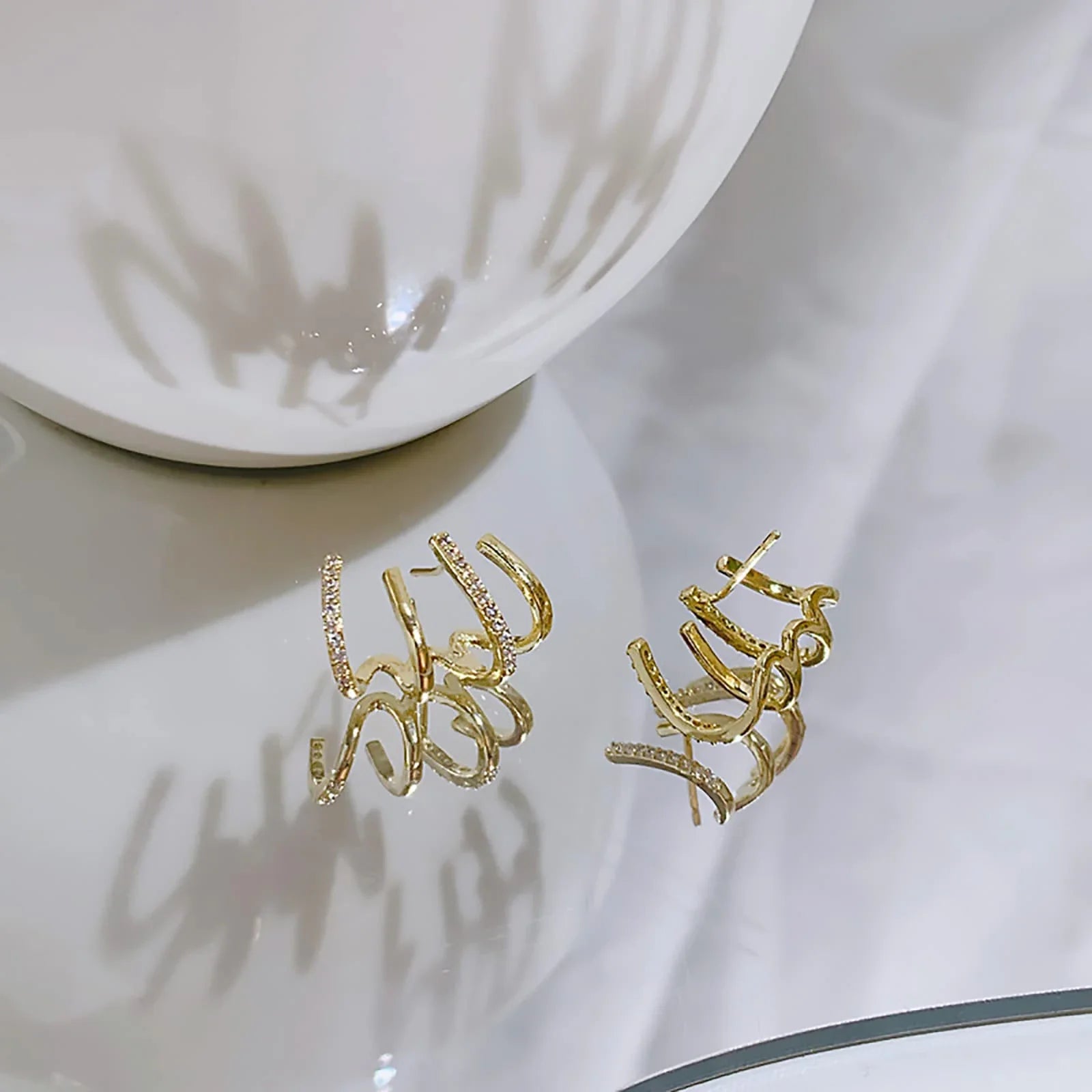 Elegant zircon four-claw stud earrings in a timeless gold colour, perfect for adding a touch of sophisticated style to any outfit.