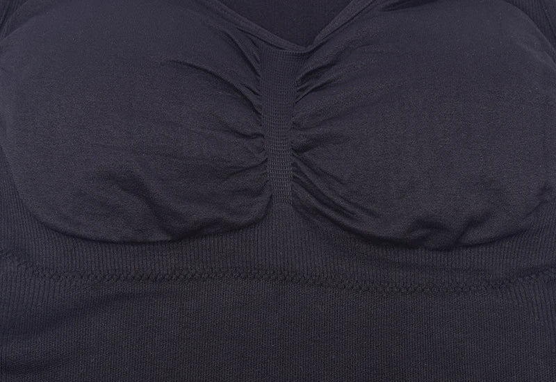 A close-up image of a black compression vest with a built-in bra, designed to sculpt and support the figure.