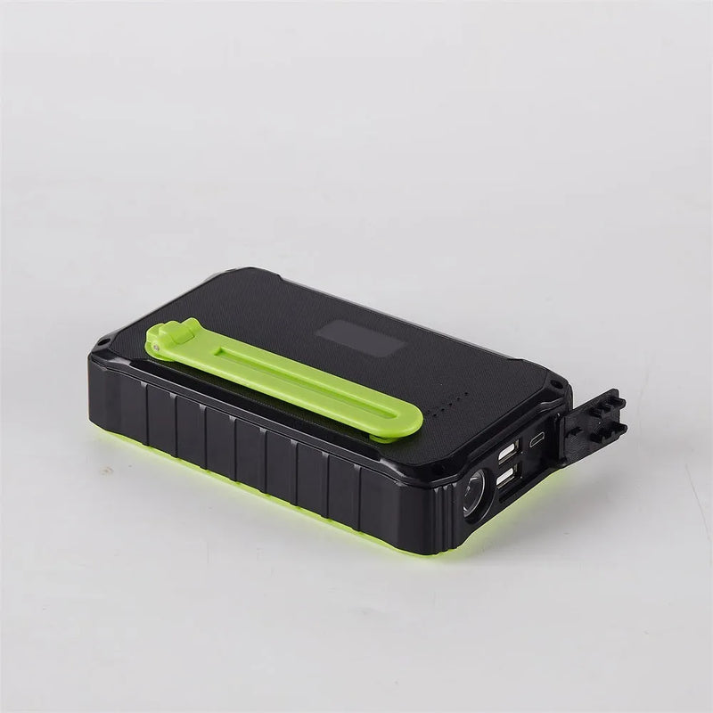 Portable solar power bank with 12000mAh capacity featuring dual USB 5V/2.1A output, hand crank generator, and integrated LED light - available in orange and green ABS plastic casing