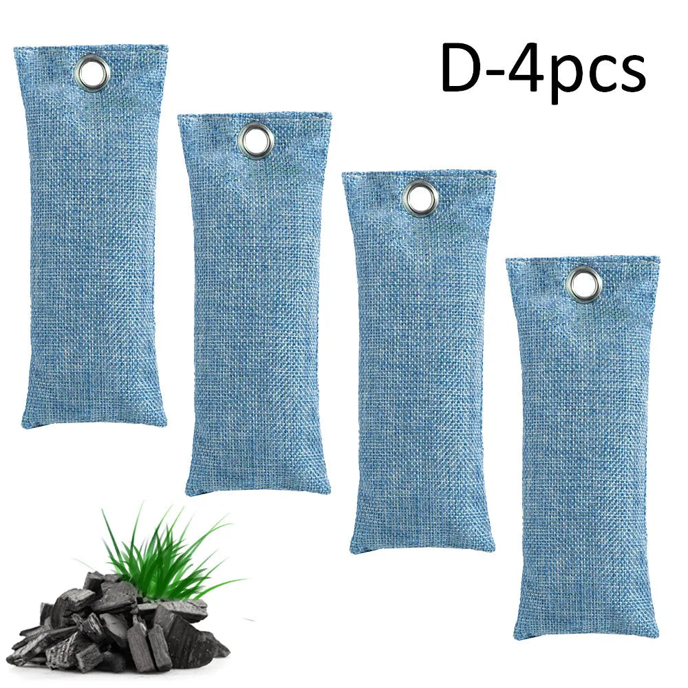 Set of black, green, grey, and blue rectangular bamboo charcoal deodorising bags on a white surface.