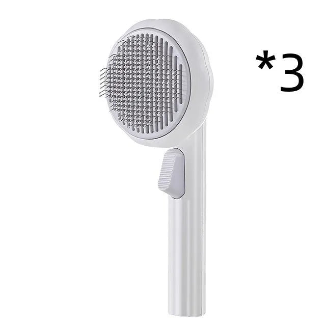 Hand-held pumpkin-coloured pet brush with stainless steel needles for grooming cats and dogs