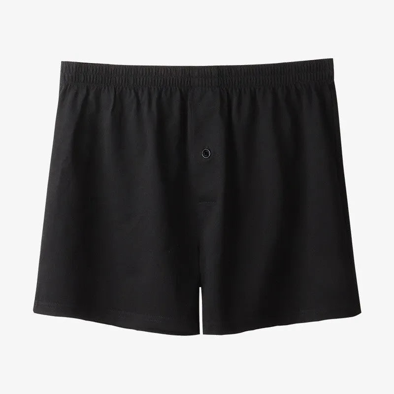 Men's light grey cotton boxer shorts with a loose fit and high waist on a plain background.