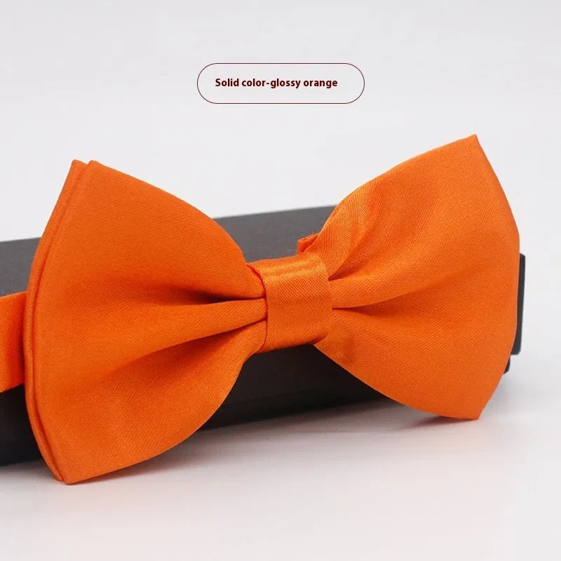 A solid colour pre-tied bow tie with an adjustable neck strap, shown in a classic flat head shape.
