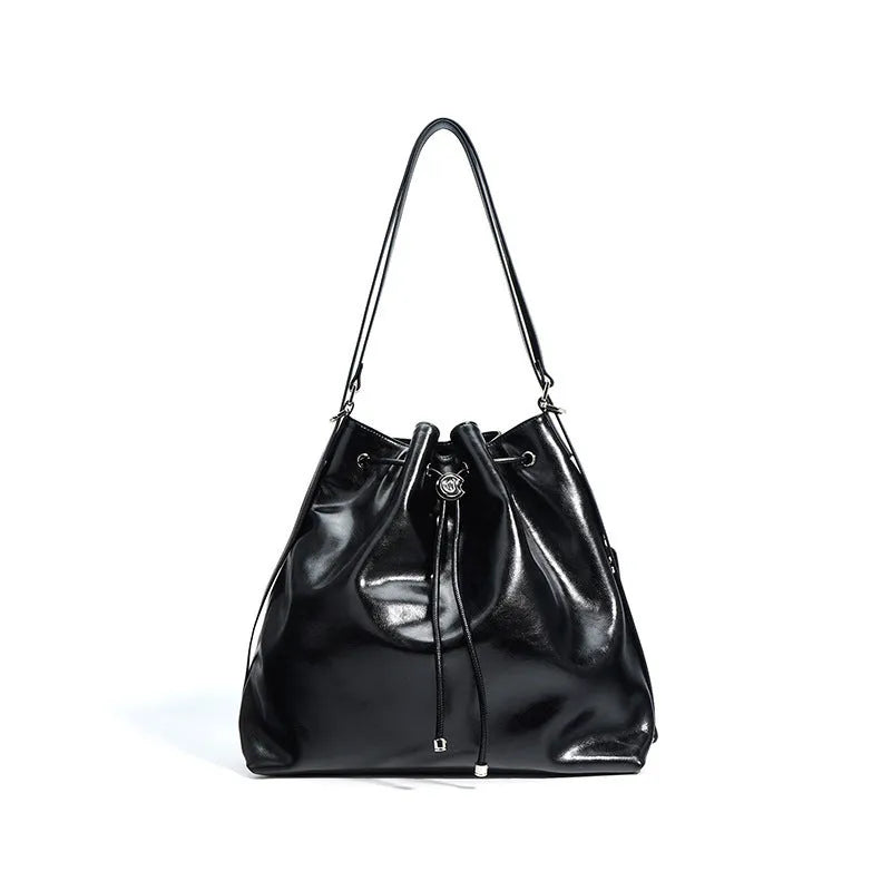 Brown genuine leather retro-style bucket bag with a single shoulder strap showing internal zipped compartments.