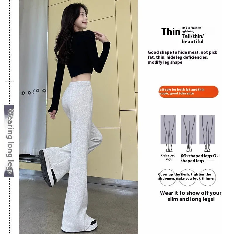 Women's high waist bootcut sports pants in black cotton with fleece lining and micro elasticity, slightly flared leg.