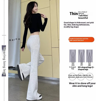 Women's high waist bootcut sports pants in black cotton with fleece lining and micro elasticity, slightly flared leg.