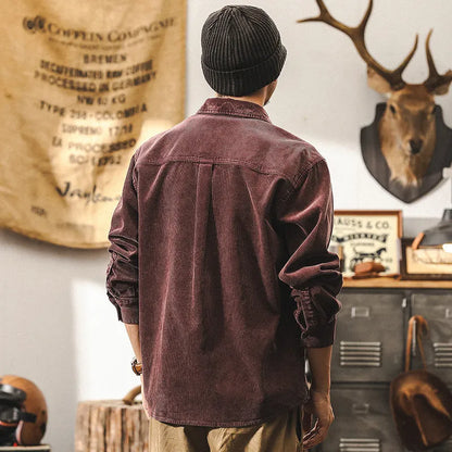 Men's red corduroy loose-fit shirt jacket with long sleeves, showing front view.