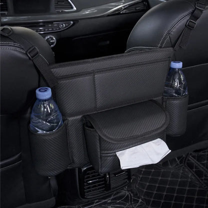 Black leather car seat gap storage bag hanging from armrest with tissue box, showing textured grain detail.