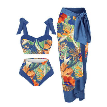 Women's pink and floral print split swimsuit three-piece set with skirt, bra, and panties.