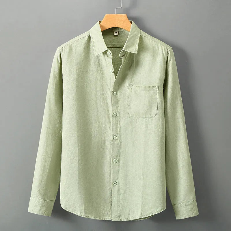 Man wearing a loose-fit light grey long sleeve linen cardigan shirt with a Chinese style design.
