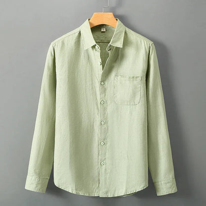 Man wearing a loose-fit light grey long sleeve linen cardigan shirt with a Chinese style design.