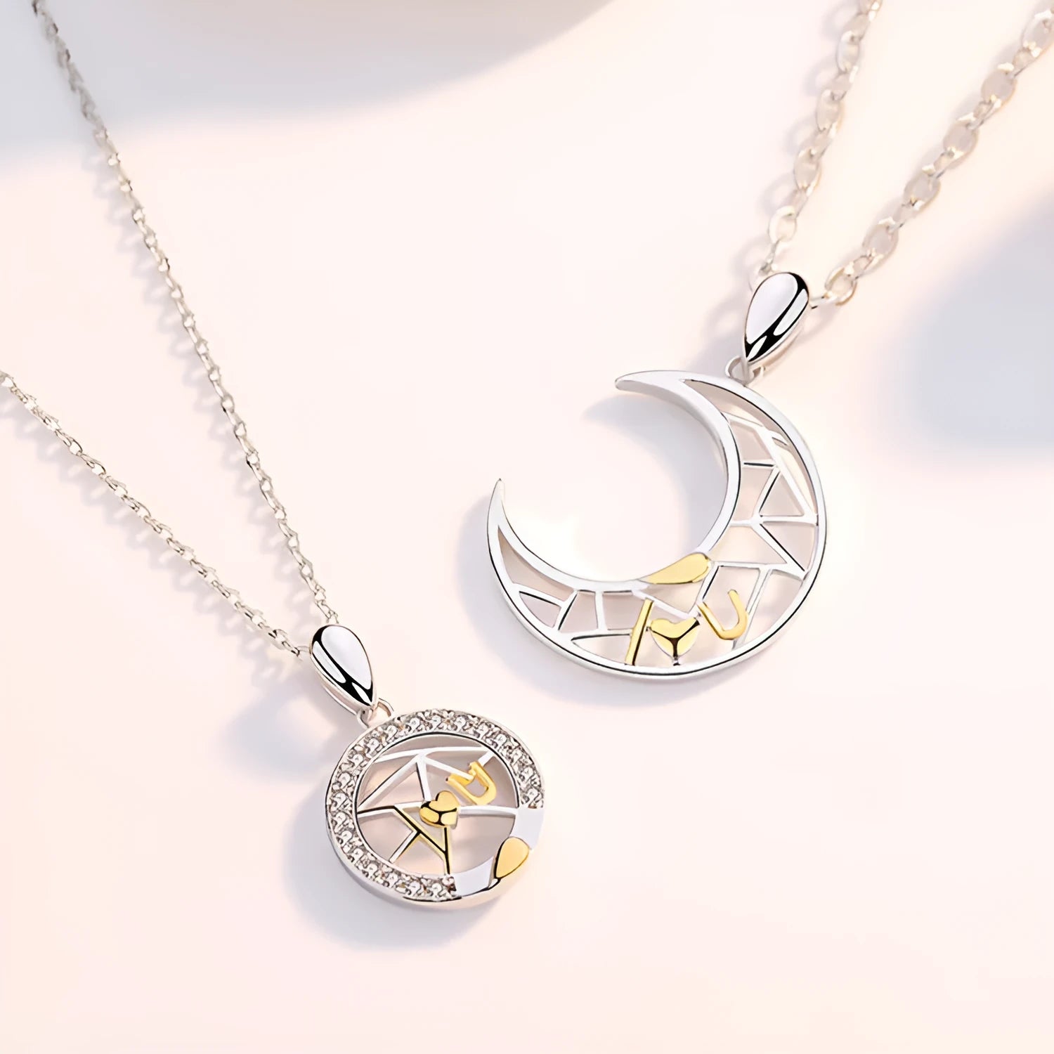 Sun and Moon copper couple's necklaces on a dark background, showing the detailed 4.5cm pendants and cross chain.