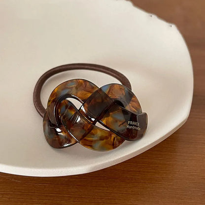 Seamless acetate hair rope ring in black, plaid, caramel, and dark coffee colours.