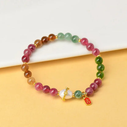 Chalcedony and tourmaline geometric bracelet with 6.5mm beads on a wrist.