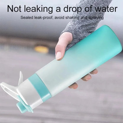 White spray water bottle with black leakproof lid and handle strap on a table