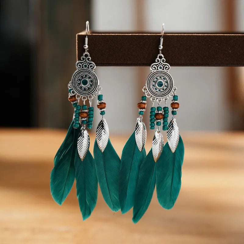 Round drop feather earrings in a bohemian leaf shape with patterned detail, shown in a light pink electroplated colour.