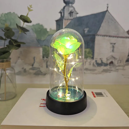 Glass cover small night lamp with plastic flowers, 15cm height, black base, showing colour light options