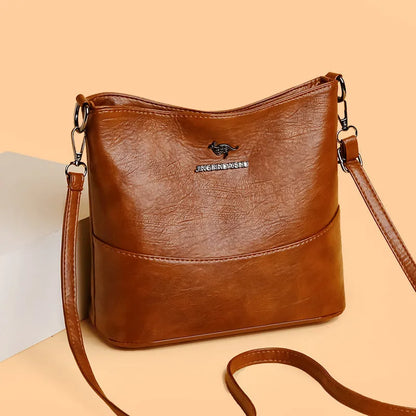 Women's soft leather bucket shoulder bag in black, wine red, or ginger yellow with large capacity and minimalist design
