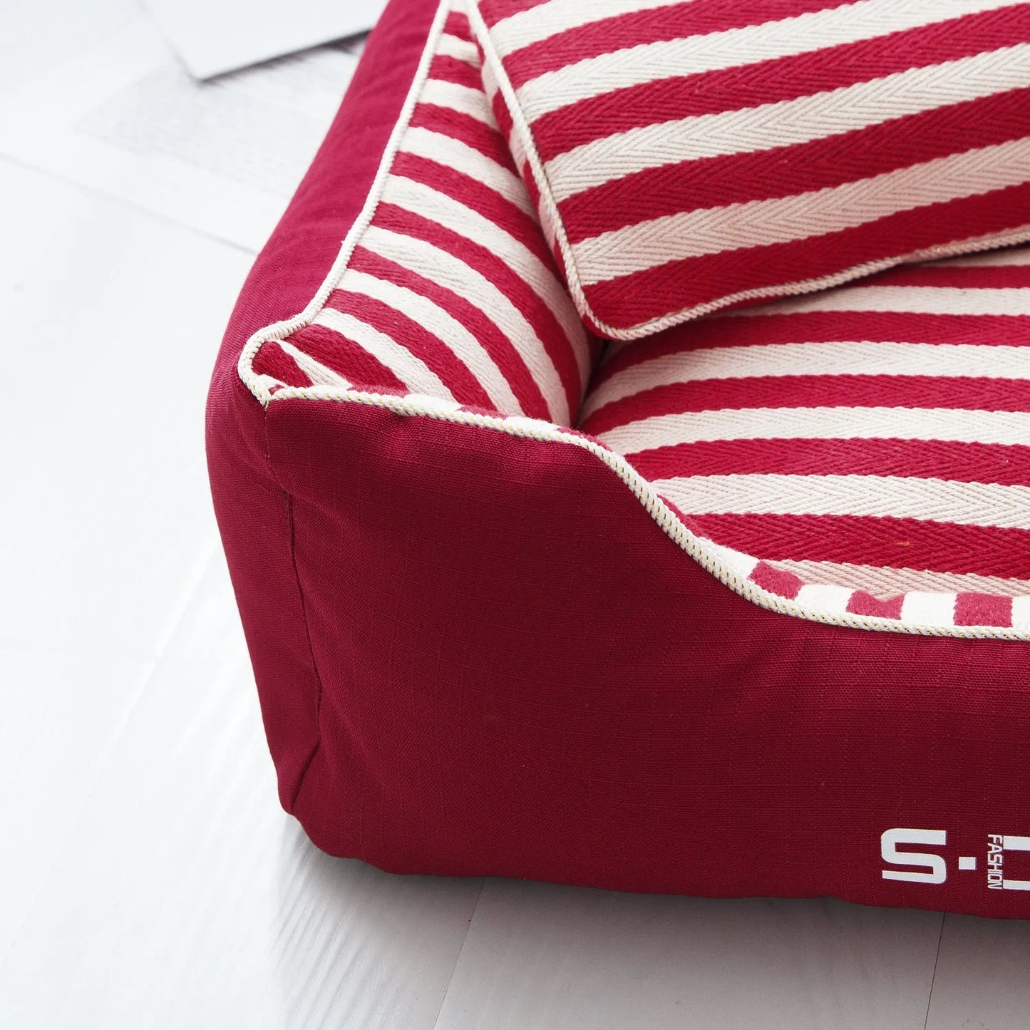 Removable washable dog kennel mat with fabric pillow in navy stripes and blue or red colour options.