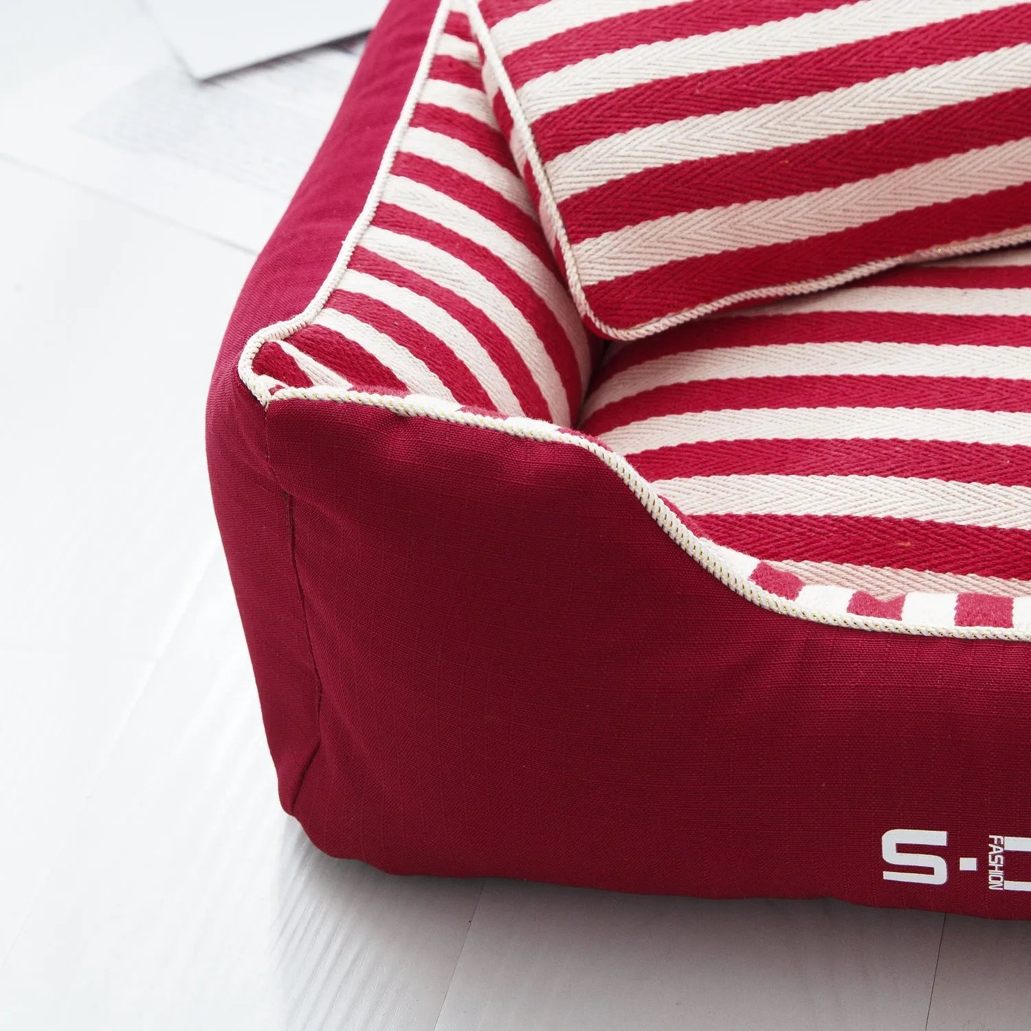 Removable washable dog kennel mat with fabric pillow in navy stripes and blue or red colour options.