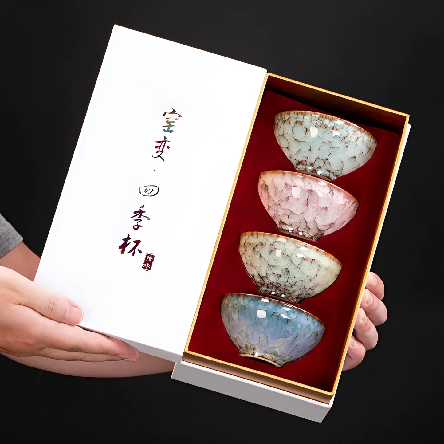 Set of four new Chinese style ceramic Kung Fu tea cups in a light-coloured gift box.