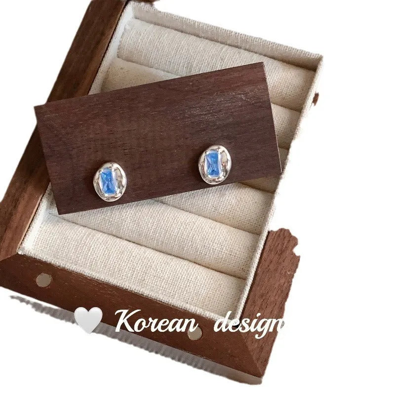 Women's S925 sterling silver oval blue diamond heart-wrapped earrings with electroplated silver finish