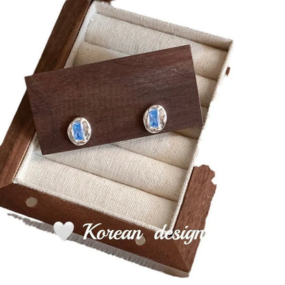 Women's S925 sterling silver oval blue diamond heart-wrapped earrings with electroplated silver finish