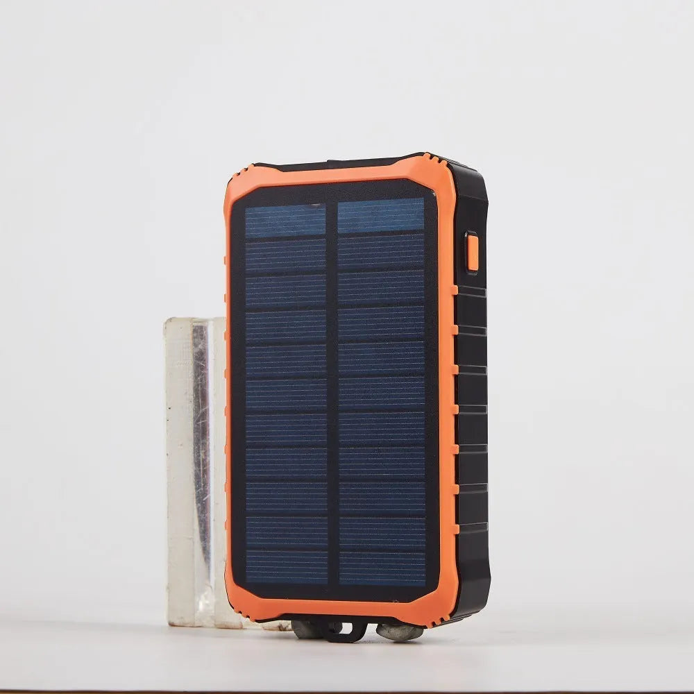 Orange and green portable solar power bank with hand crank, solar panel, and dual USB ports
