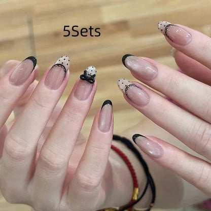 Five packs of reusable coloured false fingernails with various designs.
