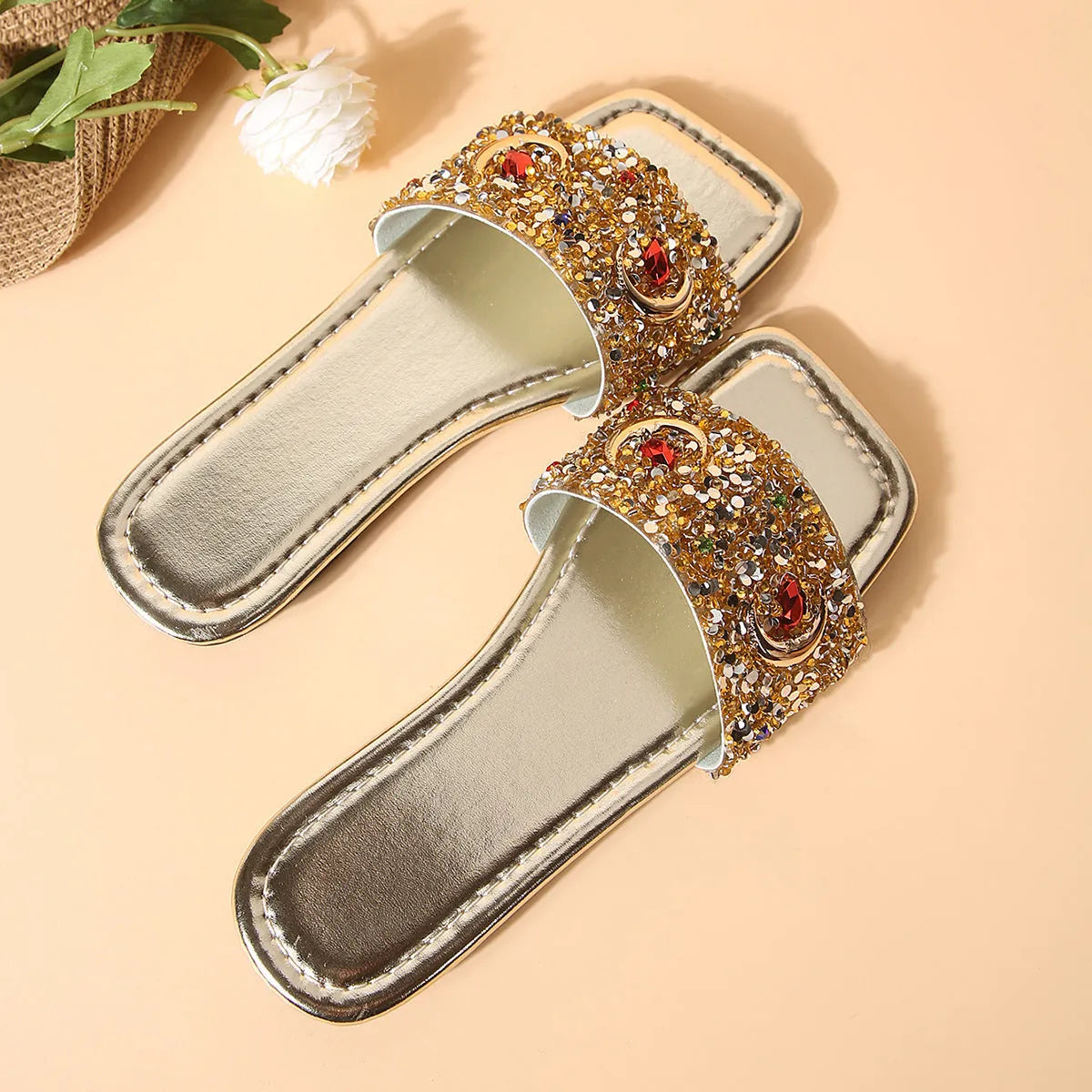 Gold women's slippers with sparkling rhinestone and sequin decoration on the PU upper.
