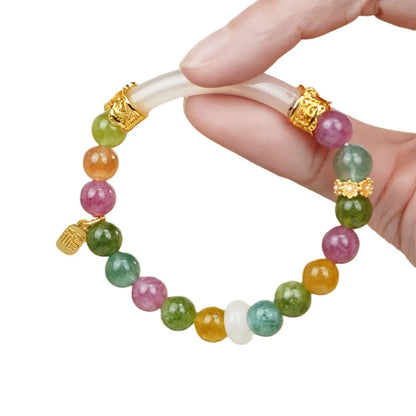 Rainbow-coloured tourmaline half bracelet for women on a wrist.