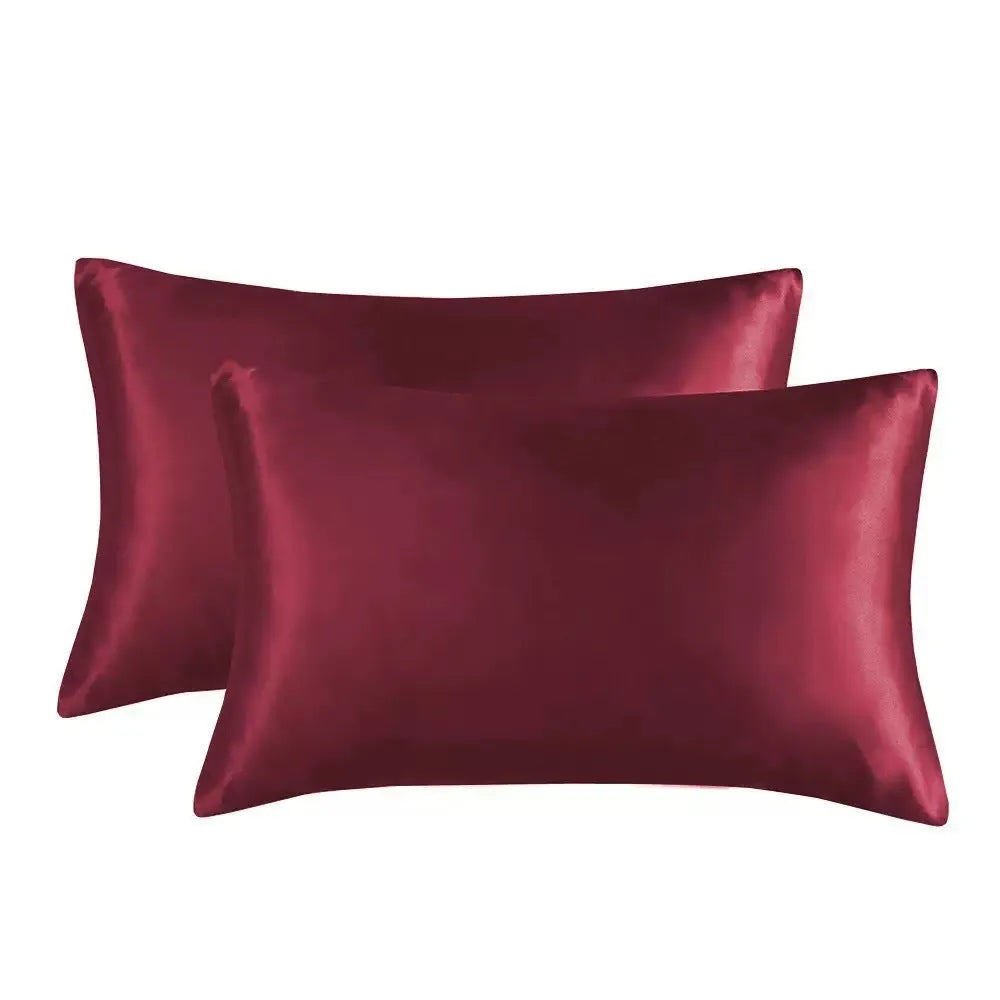 Pair of solid colour satin pillowcases showing smooth plain weave texture and reactive dye colour