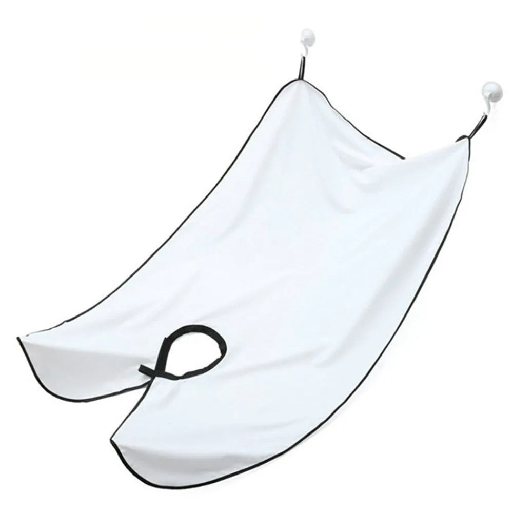 Professional transparent barber shaving cape with built-in tool tray and suction cup, shown in black.