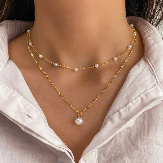 Elegant gold pearl tassel necklace with double-layered design and adjustable chain