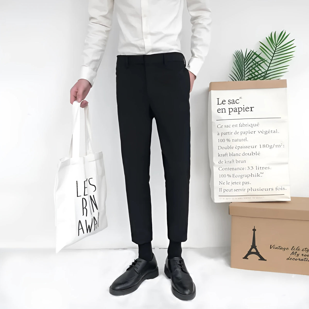 Man wearing black slim straight-leg loose fit cotton trousers with a drawstring waist