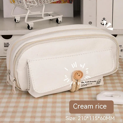 Korean style canvas pencil case with button closure, shown in beige, holding multiple pens.
