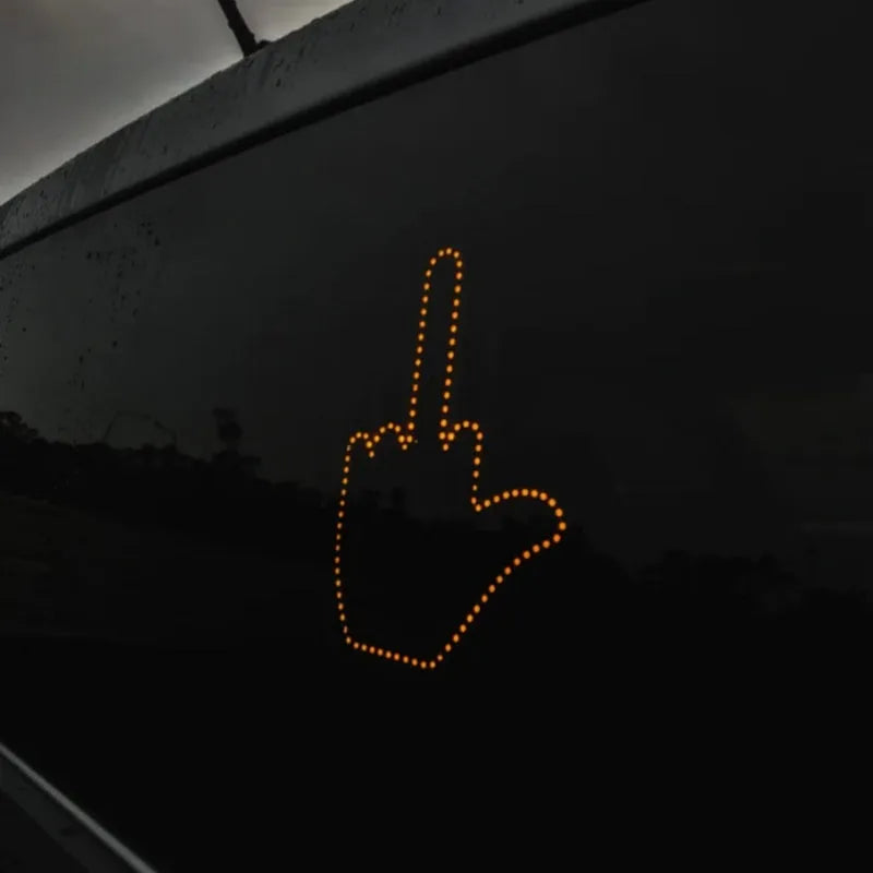 Black plastic LED gesture car light showing illuminated hand symbol, with remote control.