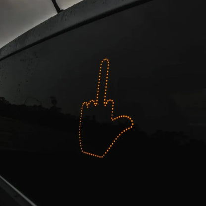 Black plastic LED gesture car light showing illuminated hand symbol, with remote control.