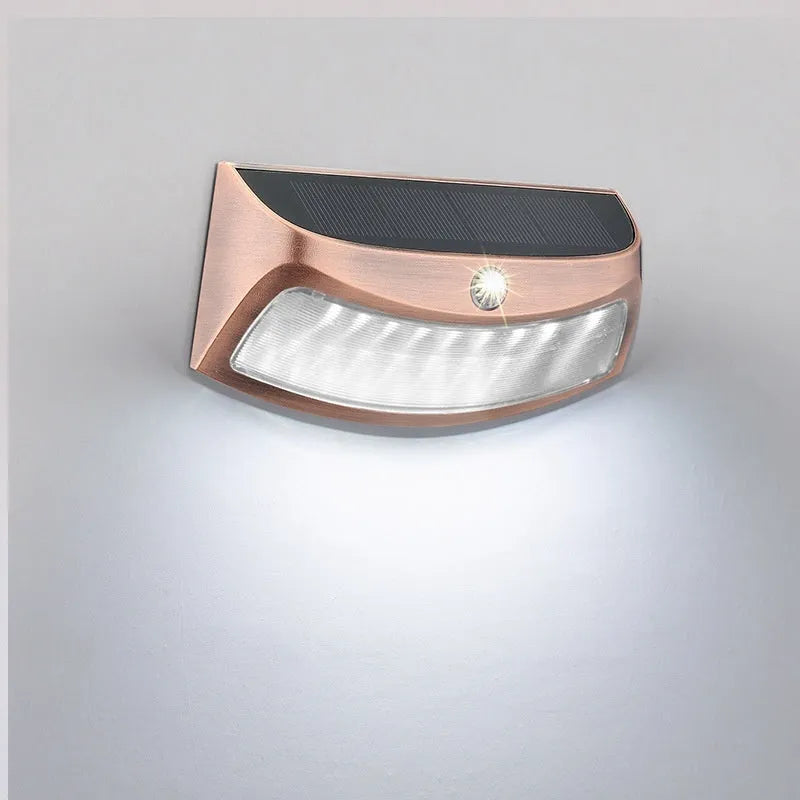 Solar outdoor wall lamp with smiling face design, dimensions 153mm by 76mm by 38mm