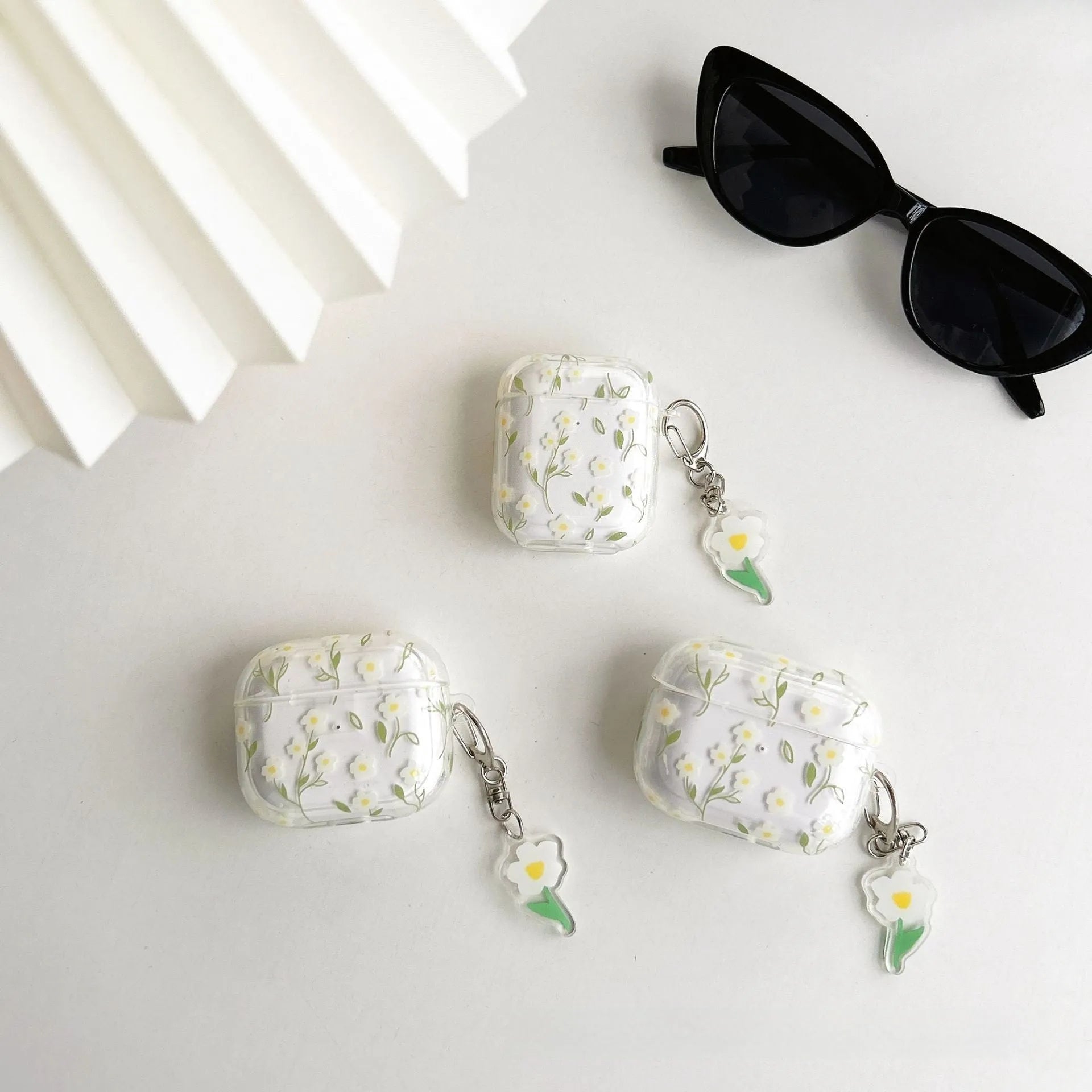 Clear white floral TPU protective cover on an Apple AirPods Pro charging case.
