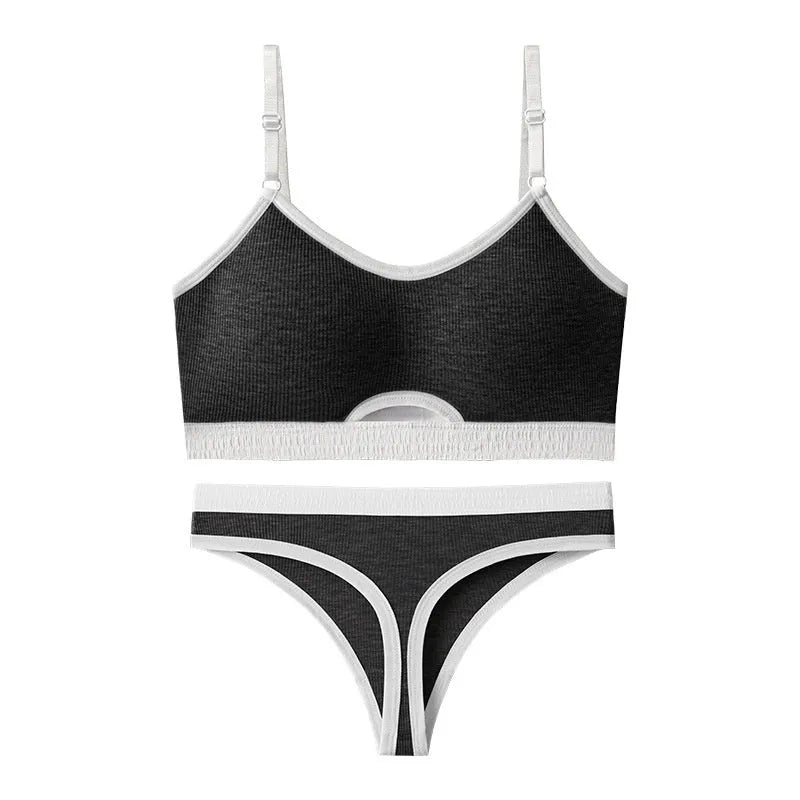 White underwired sports bra set with contrast dark grey back detailing and matching briefs on a mannequin.