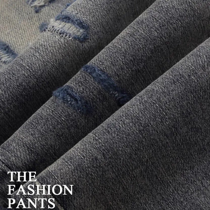 Men's slim fit cotton jeans with washed-out finish, hole patch detailing, and embroidery in old colour