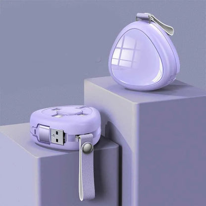 Stretchable three-in-one charging cable in green showing USB, Lightning, and Micro USB connectors retracted with buckle.